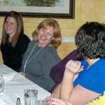 Image of PRI emploees laughing at a dinner table
