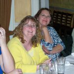 Images of smiling PRI employees at a dinner table